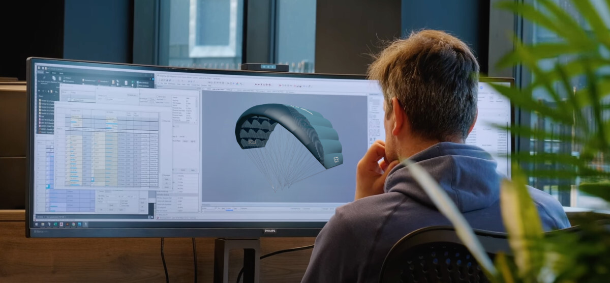 Well done, design team! A parawing designer looking at his computer screen