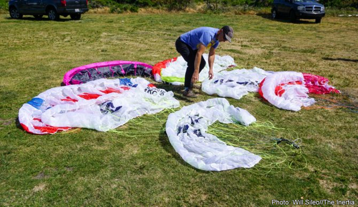 several brands of parawings laid out on the ground