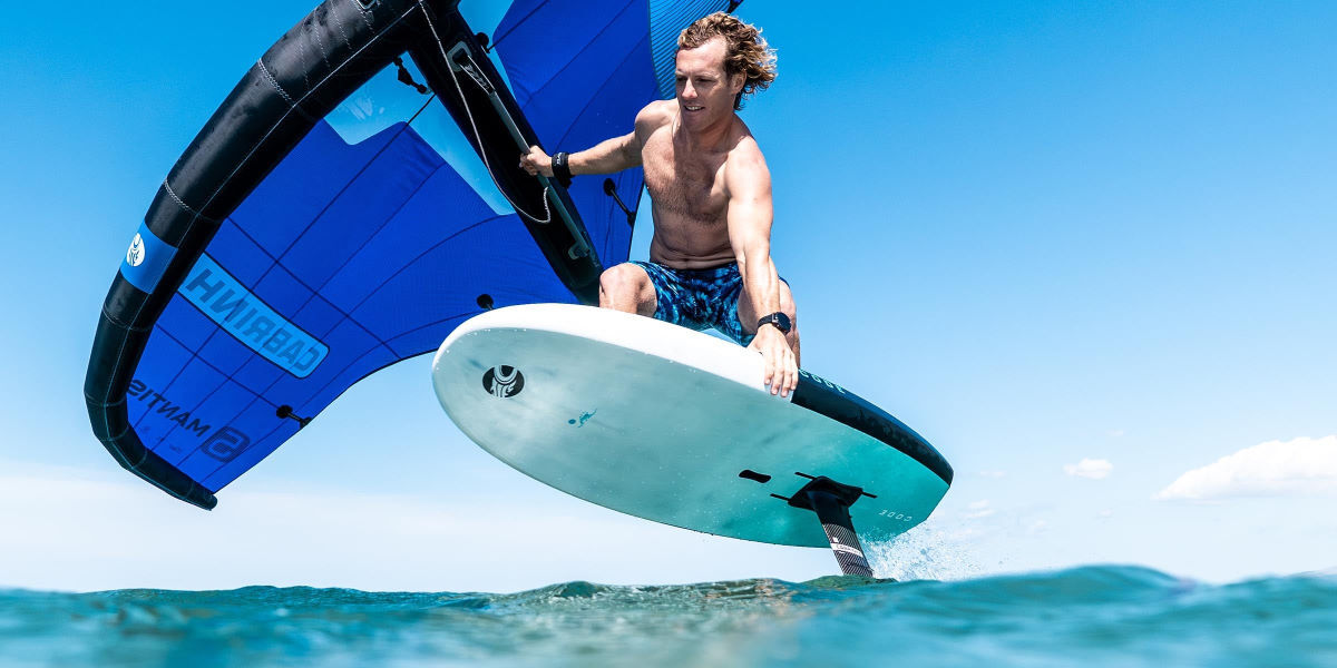 A wing foiler rides the Cabrinha Code foilboard.