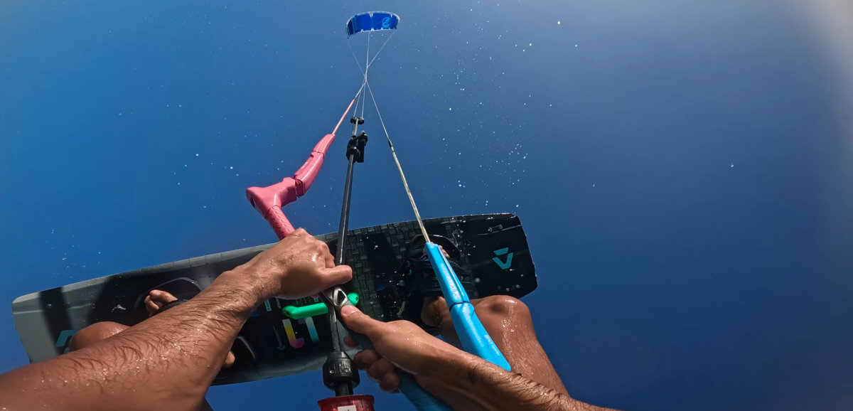 A kiteboarder pulls a hard loop on the Switchblade while jumping.