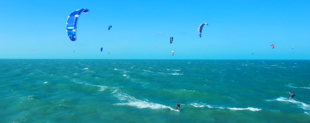 A kiteboarder rides fast across the water with a Cabrinha Switchblade.