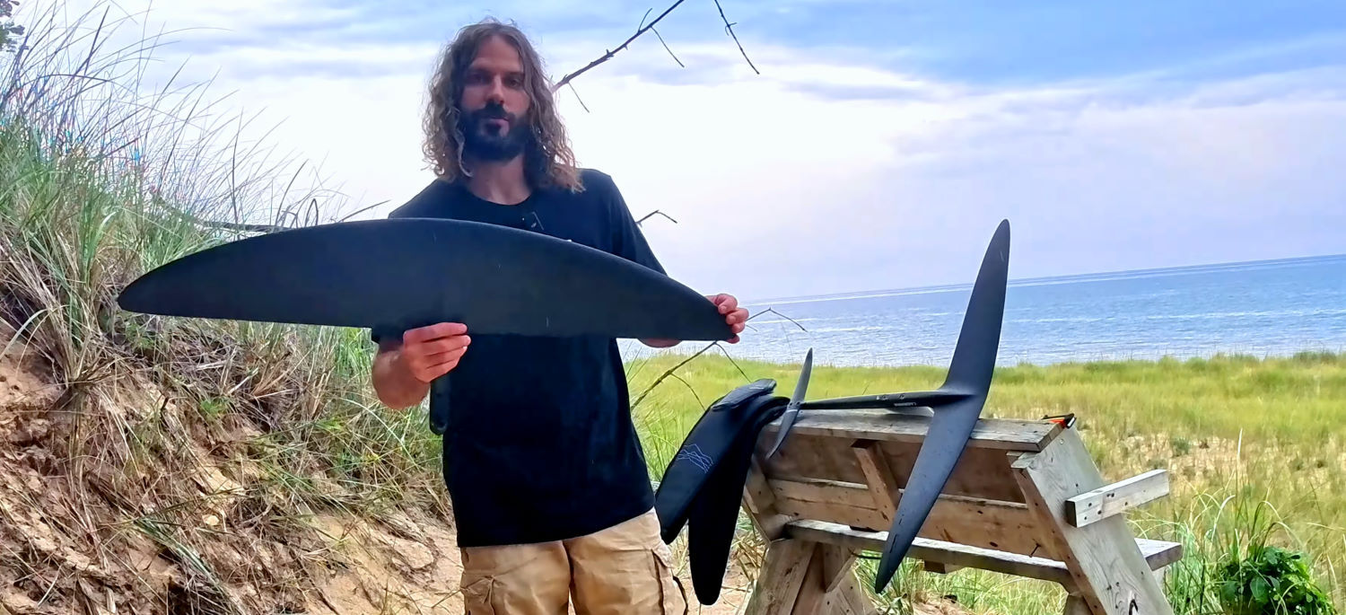 The new Origin front wing is a versatile option that goes beyond just learning to get on foil. Tucker holds up Cabrinha's new Origin foil wing.