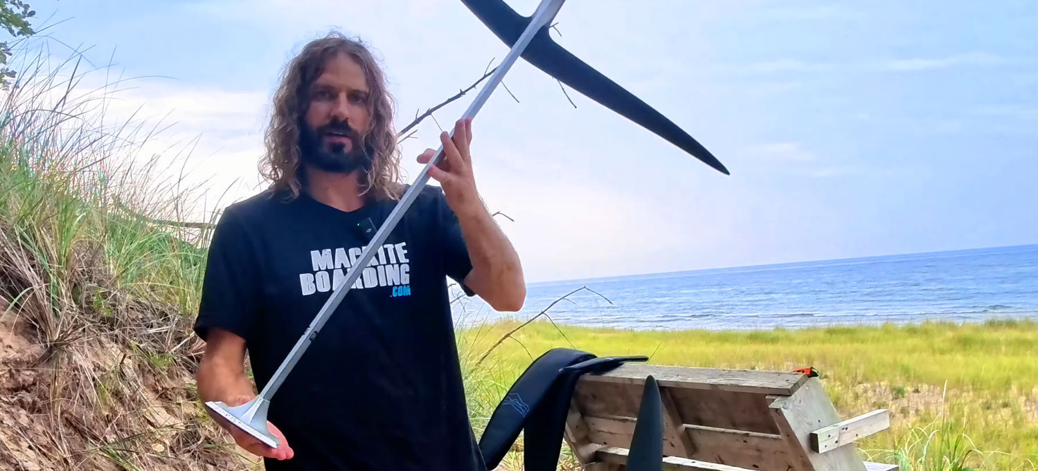 The aluminum mast is a bit more stable than the carbon mast, which is great for beginners. Tucker shows the profile of the aluminum mast.