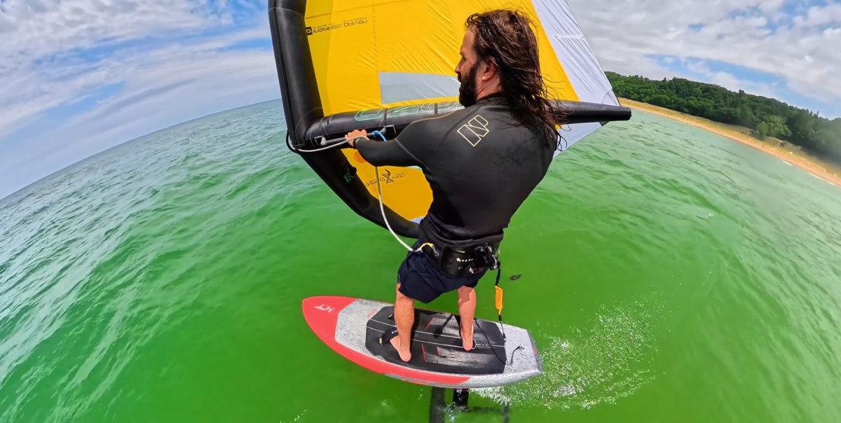 Tucker riding with a wing, board and foil on Lake Michigan.