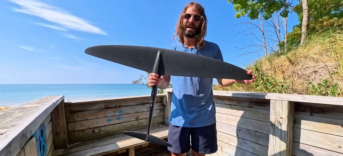 Tucker holds the 1725 front wing with the lake in the background.