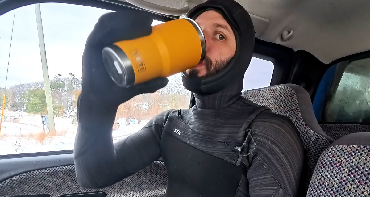 Tucker sips some warm water before heading out to ride.