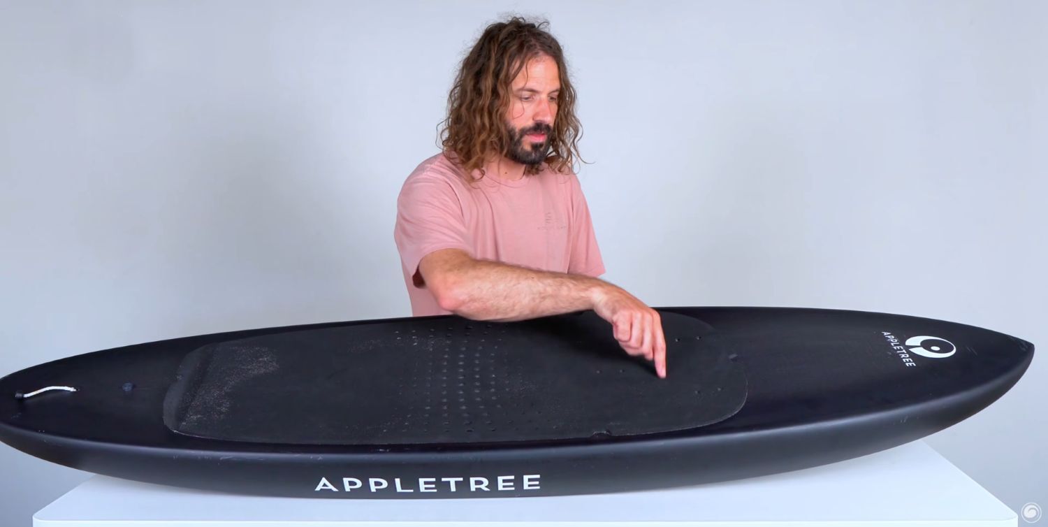 Tucker showing the deck on the Appletree Midlength V2 Foilboard