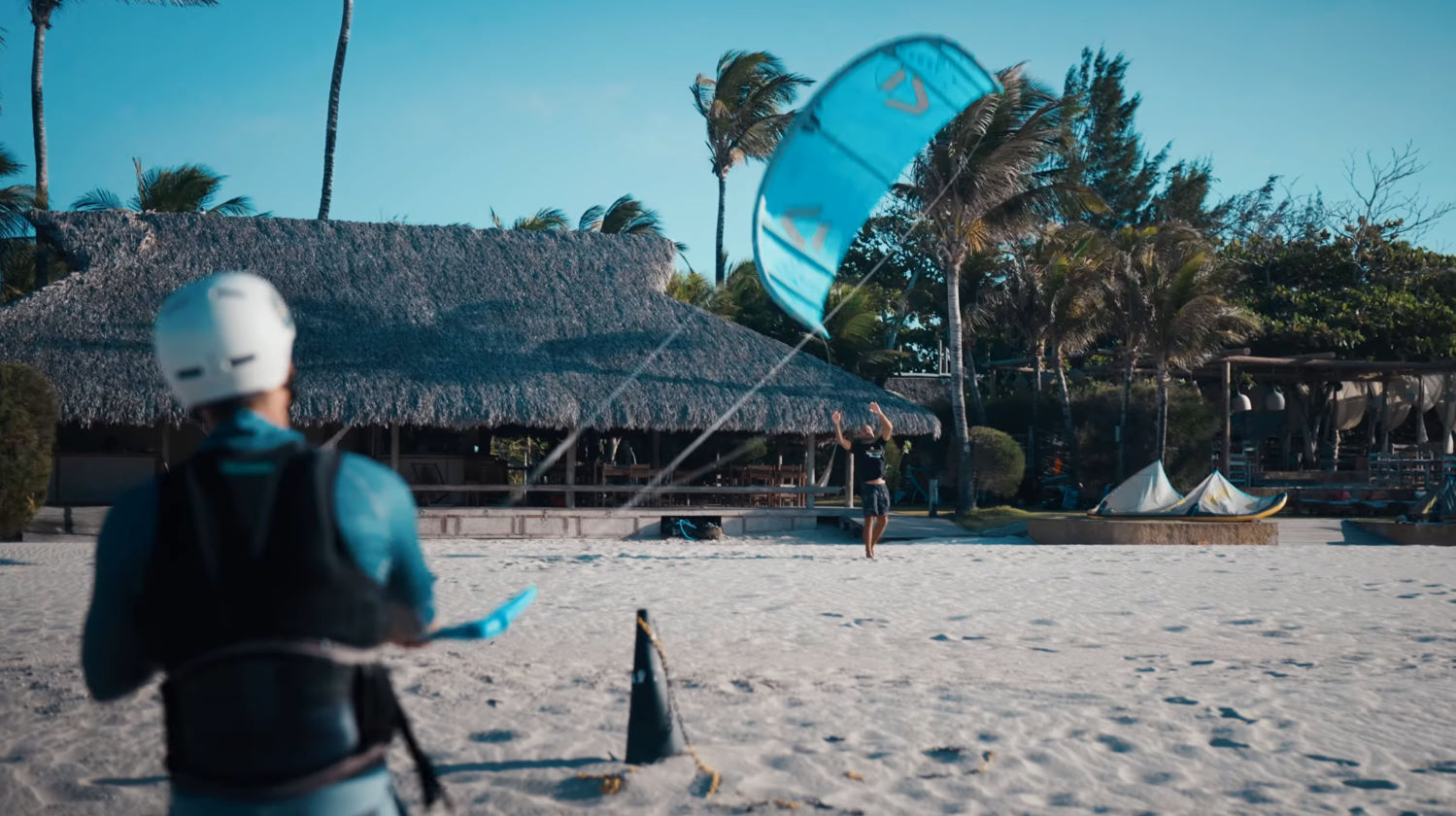 Rubens launches his kite on the beach.