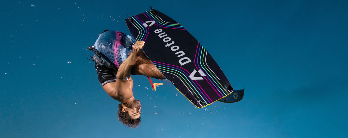 A kiteboarder jumps high on the Jaime board.