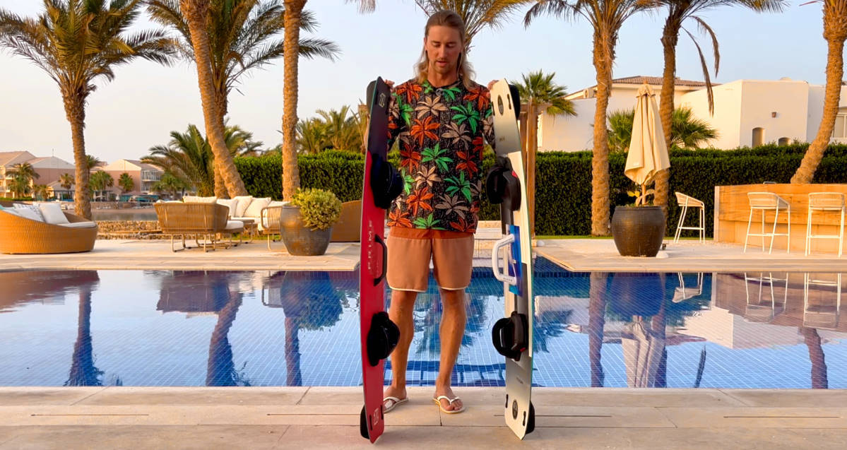 David stands with two boards, one with a standard handle and one with an extended handle.