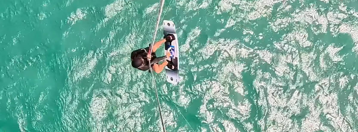 David puts his board back on his feet after a trick.