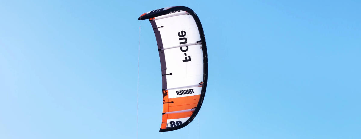The F-One Trigger TEC kite flies in the sky.