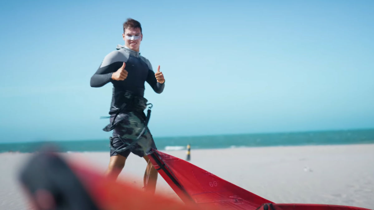 Gray is ready to test some kites! Gray Foster gives a thumbs-up as he checks over a kite.