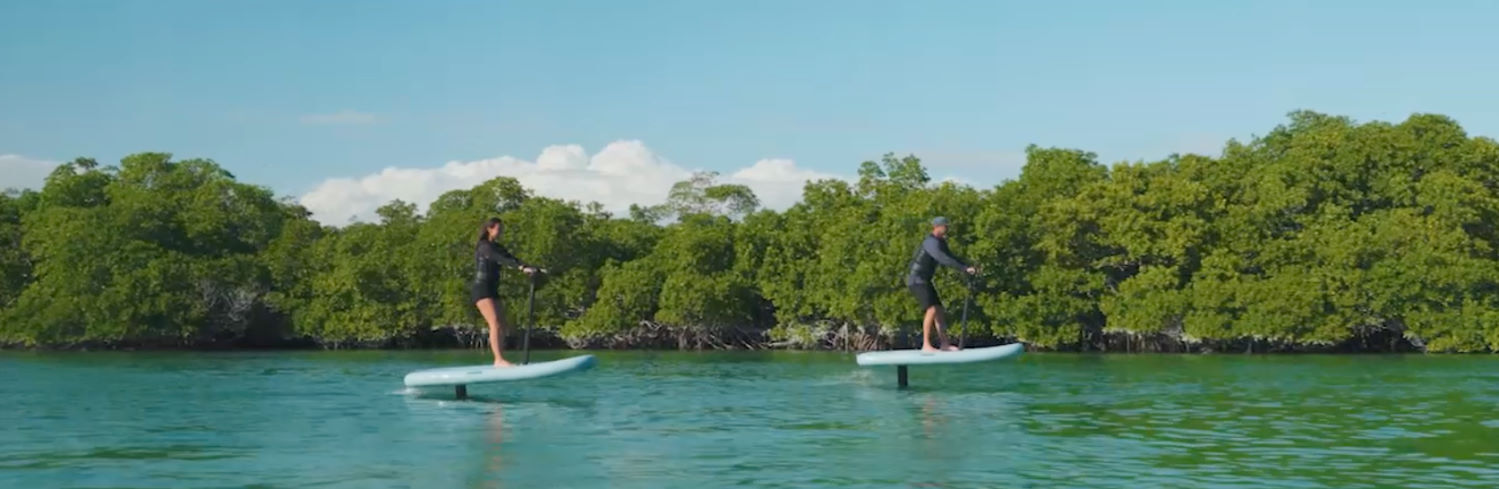 The added stability of a handlebar gives almost any rider instant success on the water. Two eFoilers cruise on the Flitescooter eFoil.