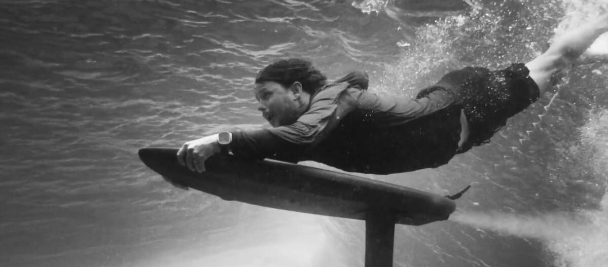 A surfer duck dives, powered by the AMPJet.