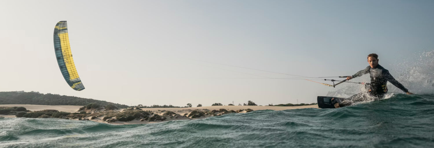 The Sonic 5 is more technical, but makes up for it with performance. A kiteboarder rides fast with the Sonic 5.