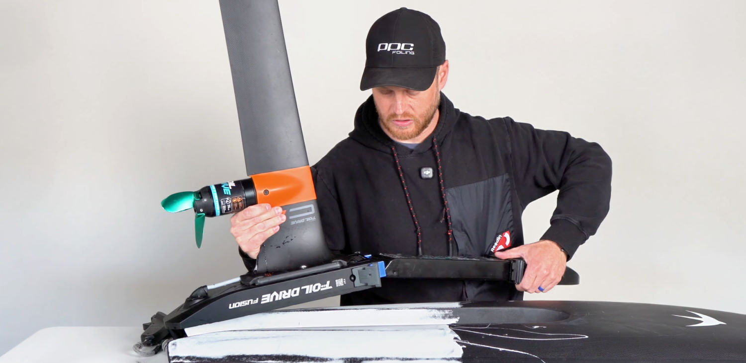Go ahead and get your board, foil, and Foil Drive Fusion all set up. Ryan tightens down the track bolts on the Foil Drive Fusion.