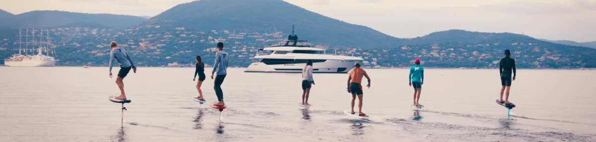 Seven people ride in a row on Foil Drives.