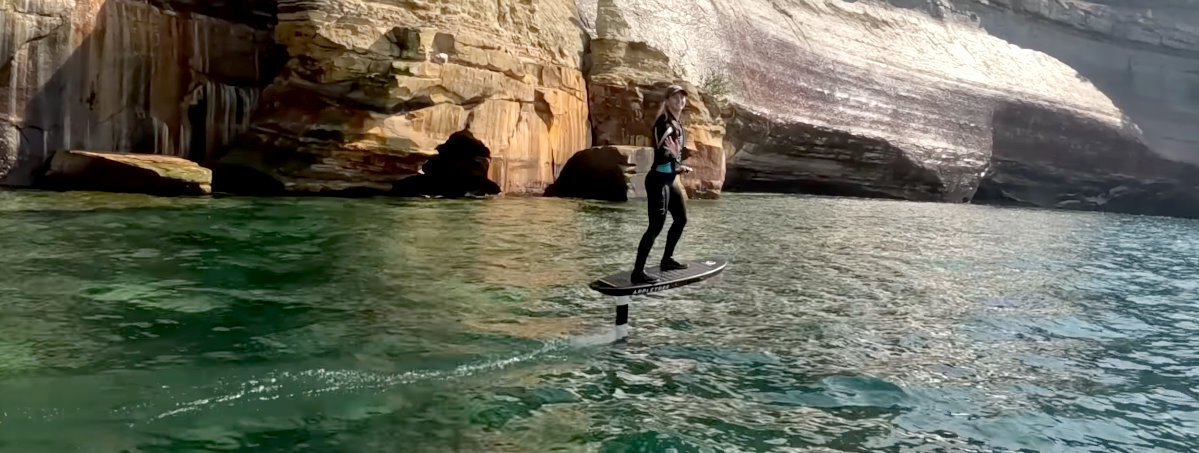 A rider cruises around in flat water on the Foil Drive Fusion.