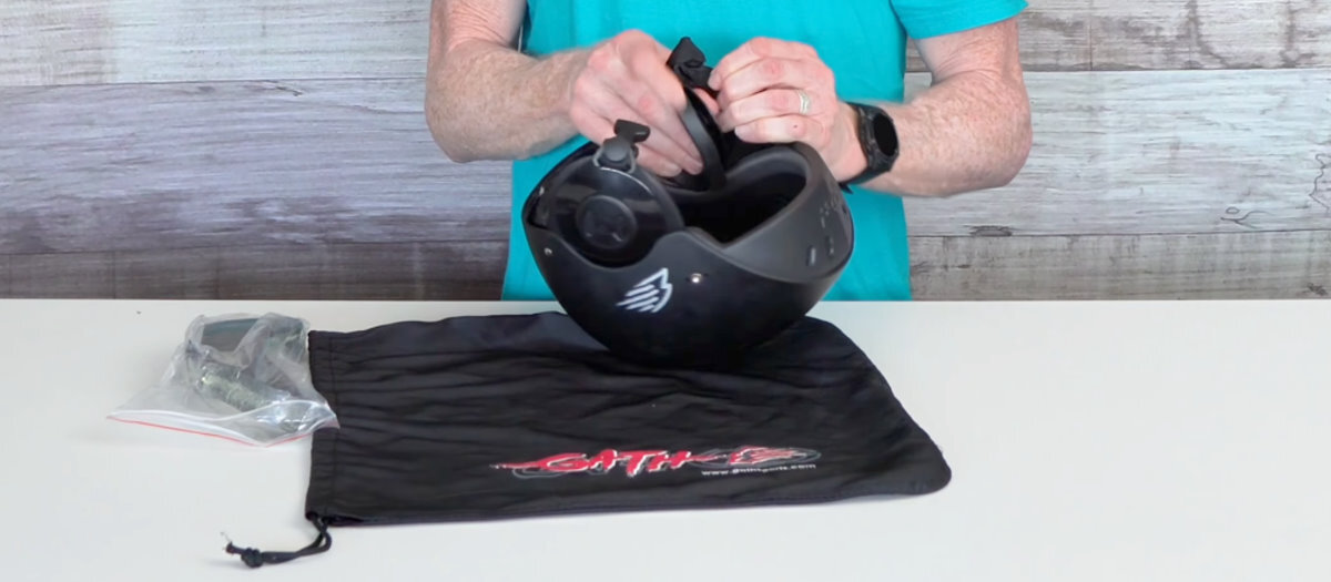 Jeff removes the ear piece on the helmet.