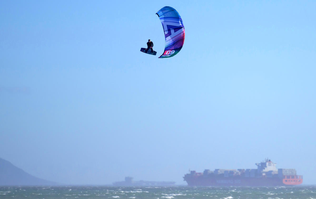 A kiteboarder jumps high with the Peak.