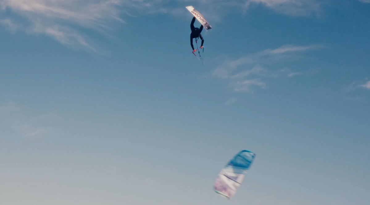 A kiteboarder loops his kite below him during a jump.