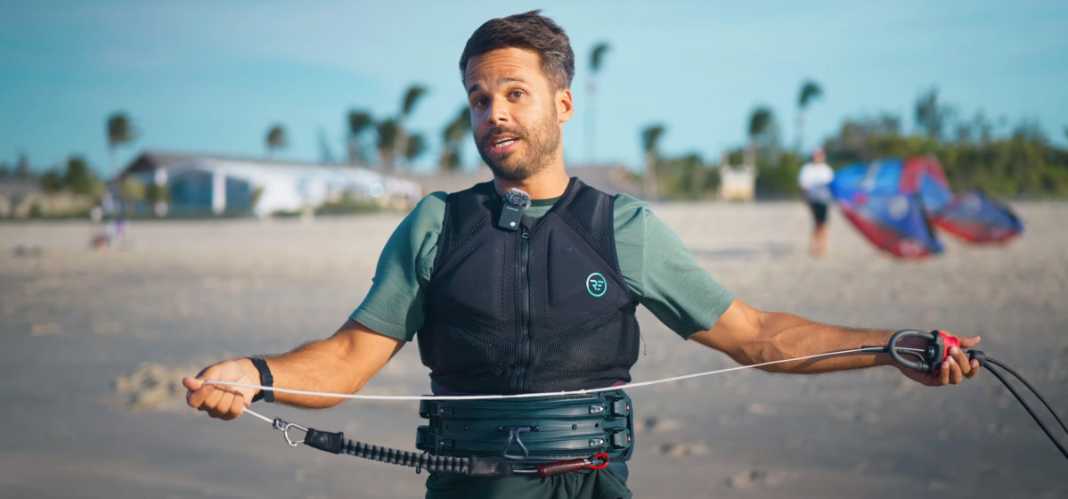 Always perform this quick safety check before a session. A kiteboarder demonstrates how to clear your safety line of debris.