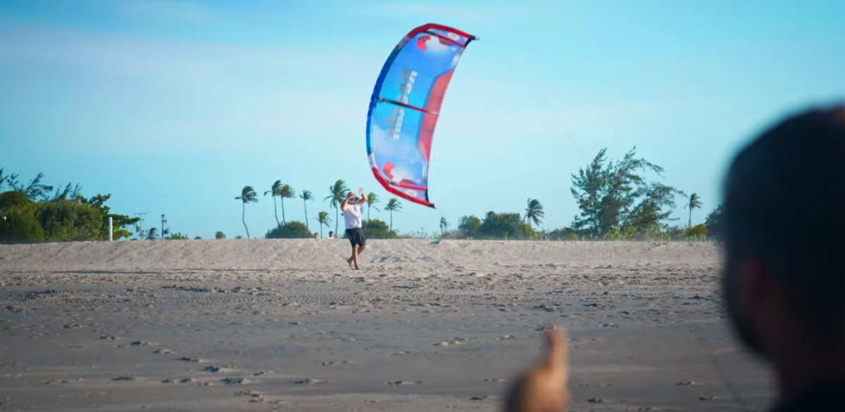 All systems go! A kiteboarder gives the thumbs-up signal for his assistant to release the kite.