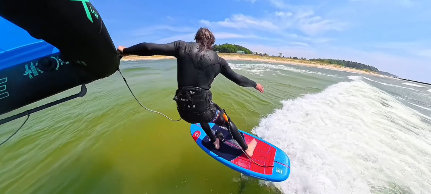 Improving your wing handling will open up new possibilities. Tucker rides a wave, holding the wing by the leading edge handle.