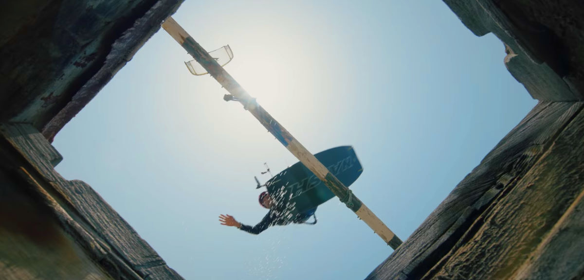 Stig is seen through the opening of a tower as he jumps over it.