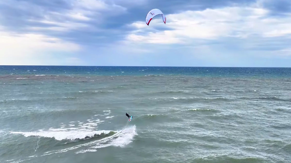 Jeff takes off on a jump using a wave.