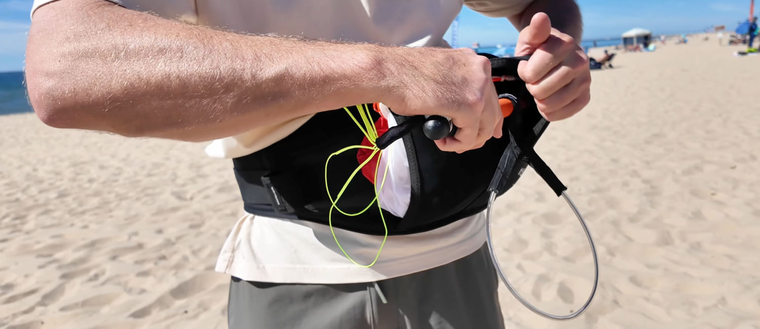 Once the wing is stowed, move the bar into its rear pocket so it's out of the way of your arms. Billy stows the bar in its own pocket on top of the parawing.