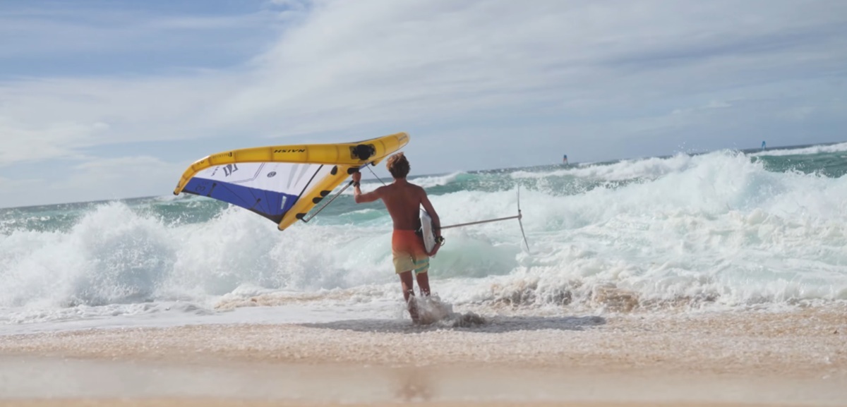 Holding on the Naish ADX NVision near the shoreline