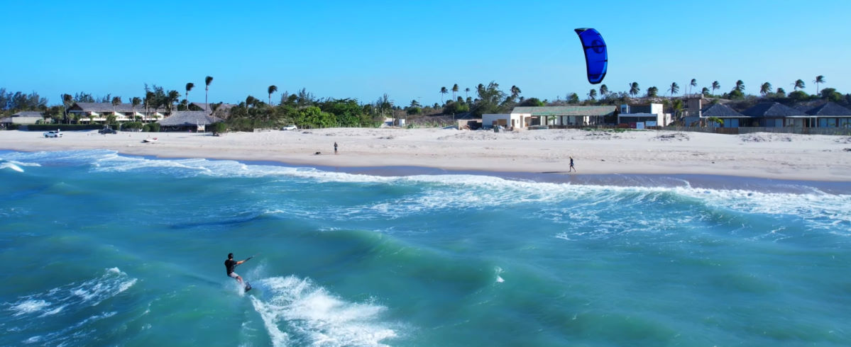 A kiteboarder skims across the water on the North Reach.