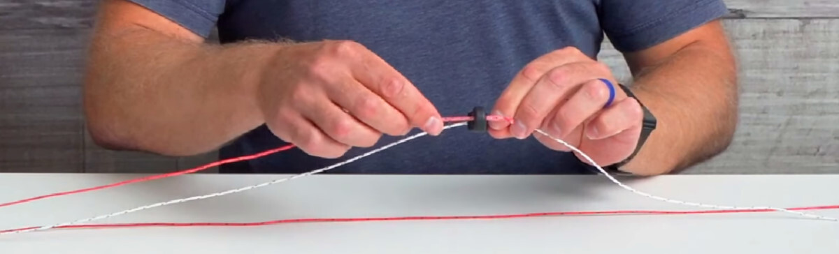 The flagging line should fit loosely through the larger hole on the adapter. sliding the flagging line through the adapter's large hole