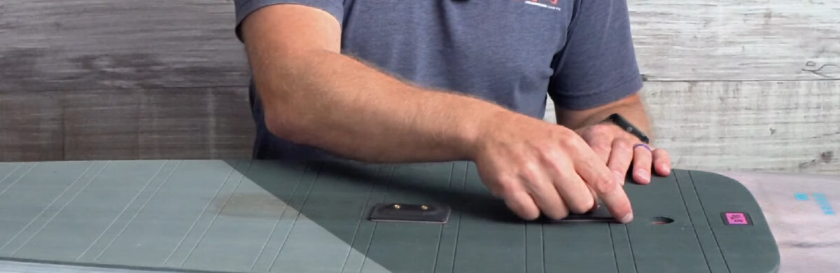 Once you know where you want your inserts, prep the deck. Ryan shows where to cut away the deck pad.