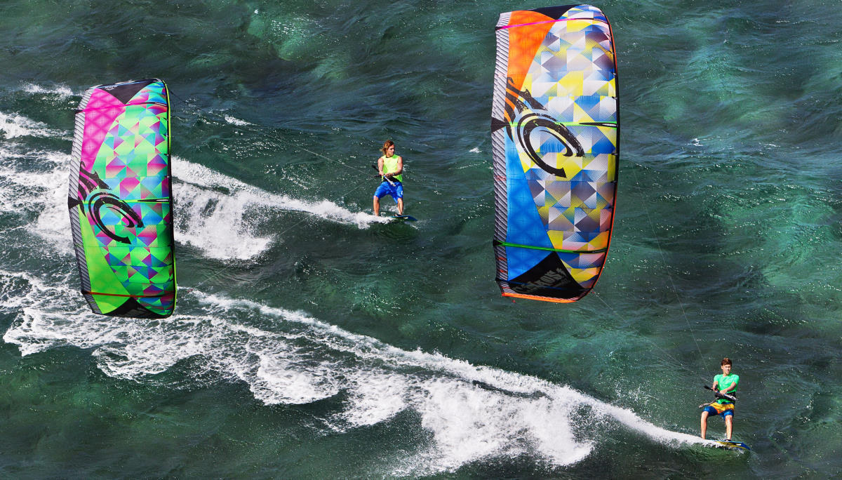 Two kiteboarders ride together with the 2014 Cabrinha Chaos.