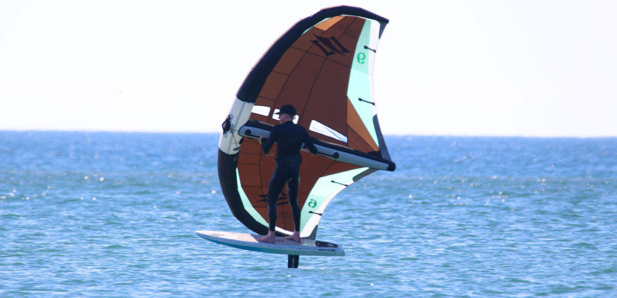 A wing foiler rides with their feet facing a little more forward.