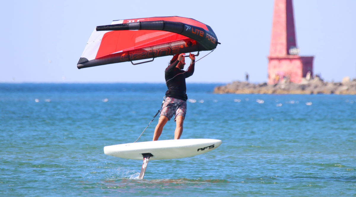 Tucker wing foils near a lighthouse.