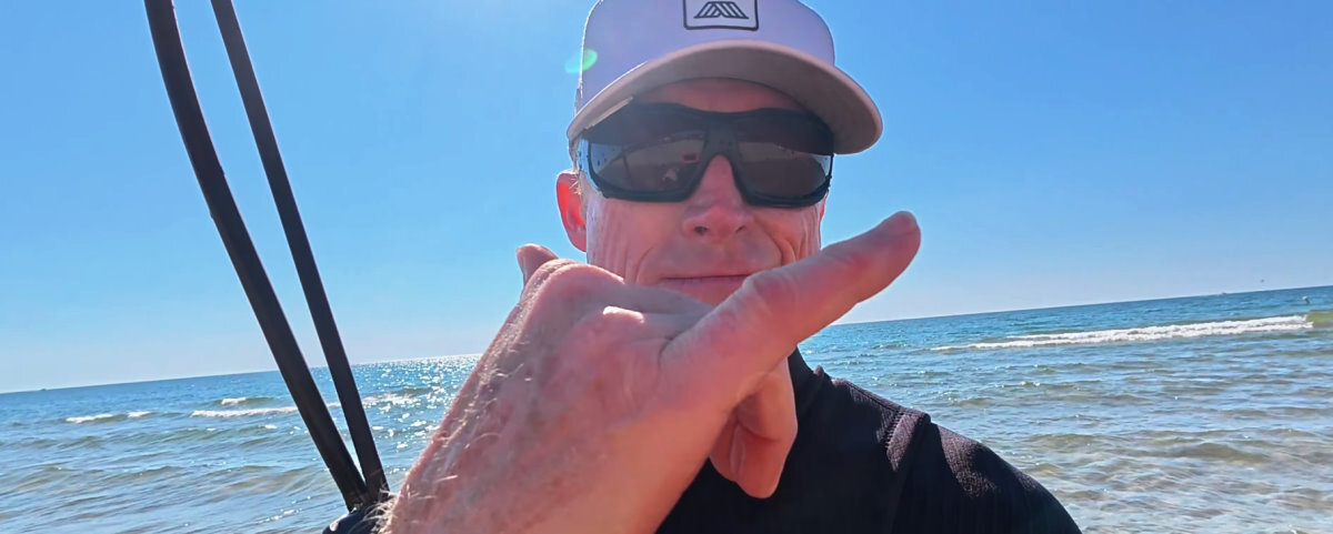 Jeff makes a shaka sign after a fun light wind session.