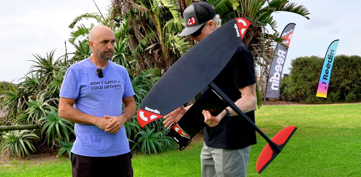 Jeff holds the package foil while Damien tells him about it.