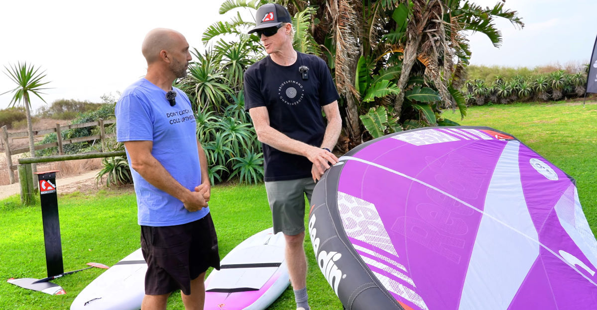 Jeff holds the package wing while he speaks with Damien.