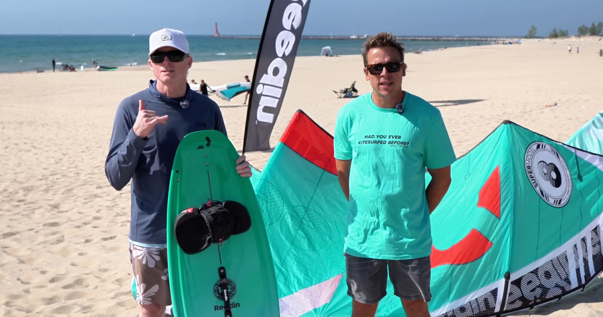 Jeff and Kevin stand on the beach with the Reedin SnackPack Hybrid Board