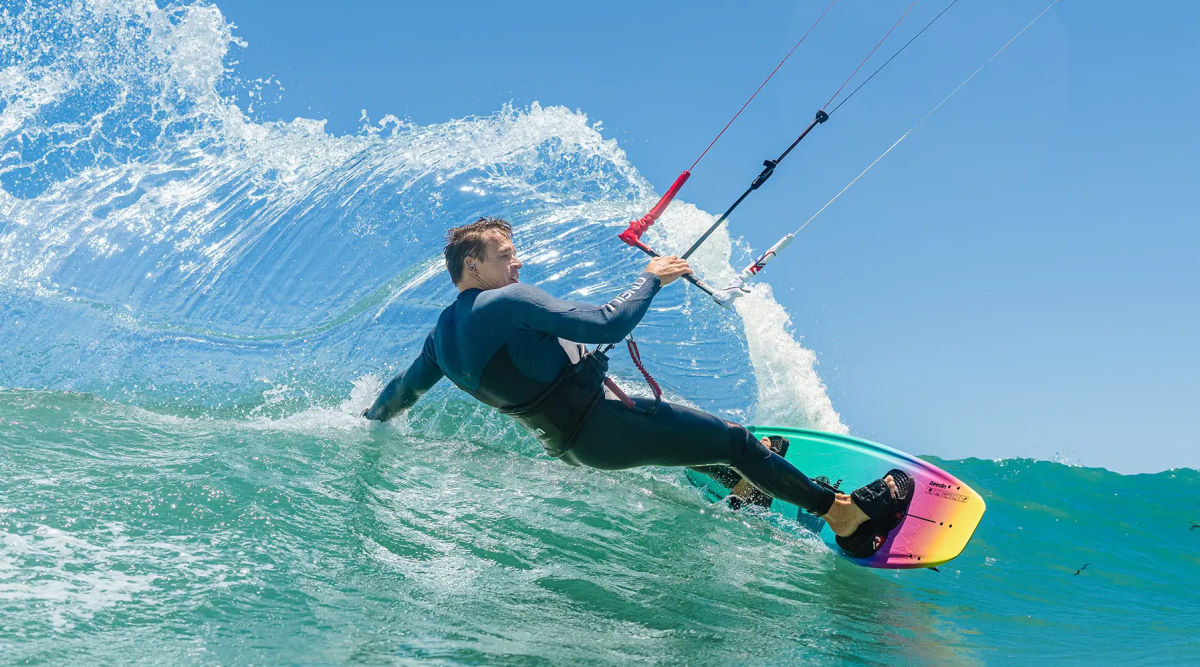 A kitesurfer carves a wave on the SnackPack.