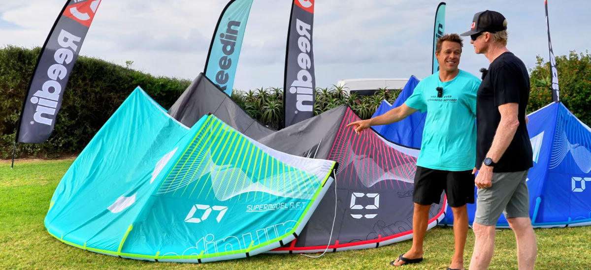 The Reedin SuperModel is still a kite for just about anyone. Kevin points to a SuperModel kite resting on the ground.