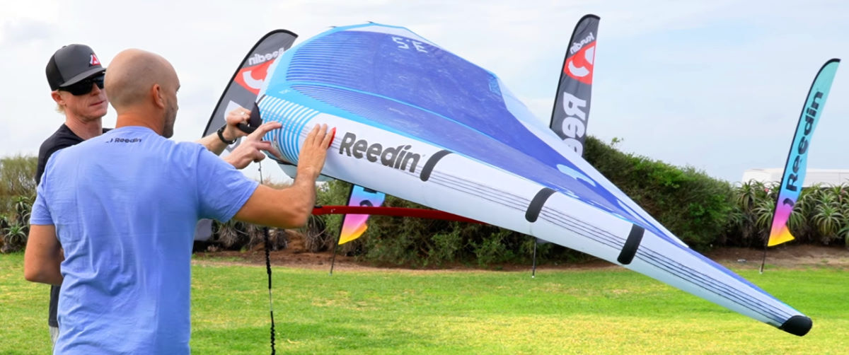 The wing's leading edge is reinforced with lightweight tape running along its length. Damien points to the reinforcing tape along the wing's leading edge.