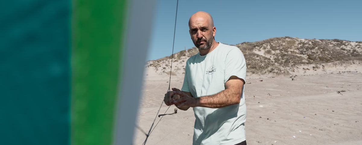 Reedin designer Damien Girardin holds the lines to a kite.