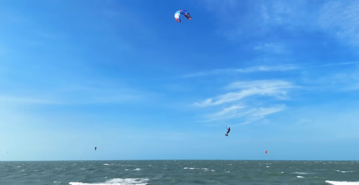 A kiteboarder jumps high with the HyperModel kite.