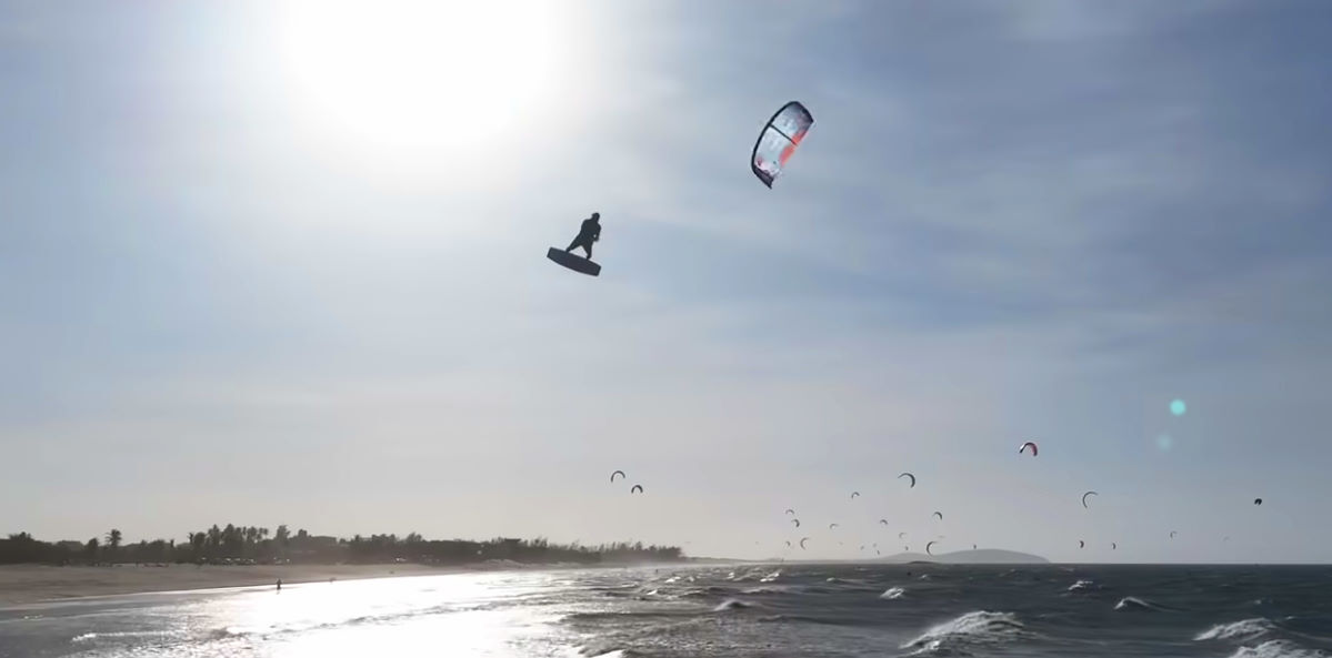 A kiteboarder loops his Reedin HyperModel kite during a jump.