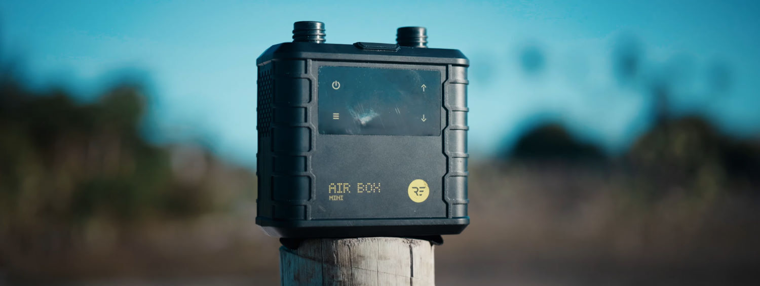 The Ride Engine Air Box Mini is small, but is it mighty? A Ride Engine Air Box Mini sits on a wooden post at the beach.